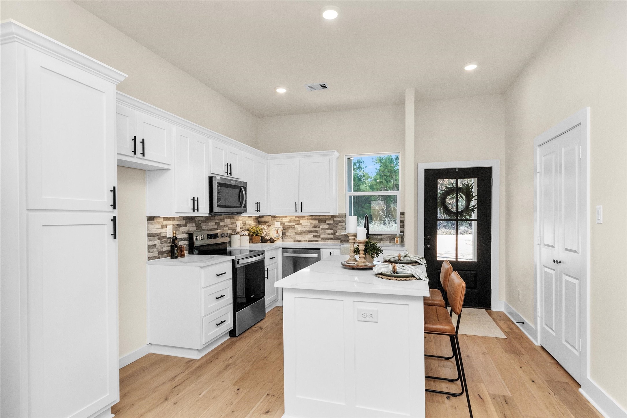 103 Canary St Point Point Blank, TX 77364 - Photo 7 of 28 a kitchen with a sink a stove and refrigerator