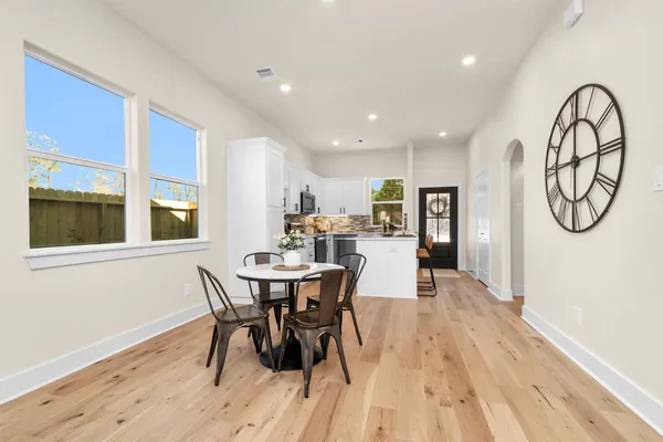 a view of a dining room with furniture window and wooden floor