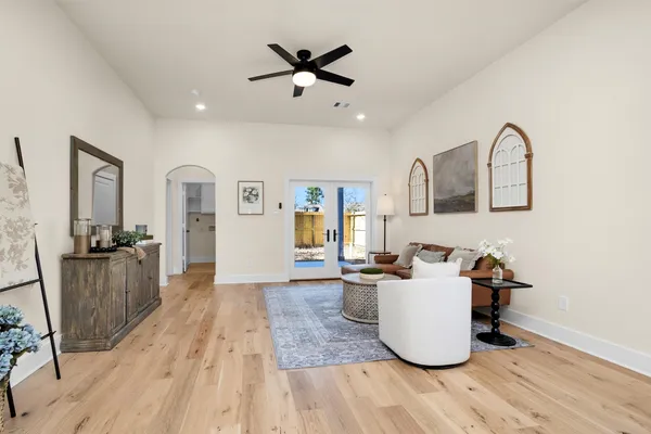 a living room with furniture and wooden floor