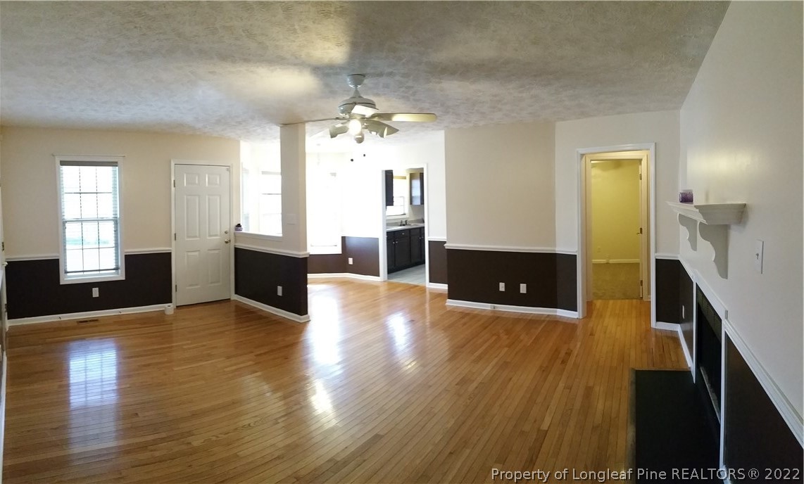 232 Rye Lane Raeford, NC 28376 - Photo 17 of 20 a view of a big room with wooden floor and staircase