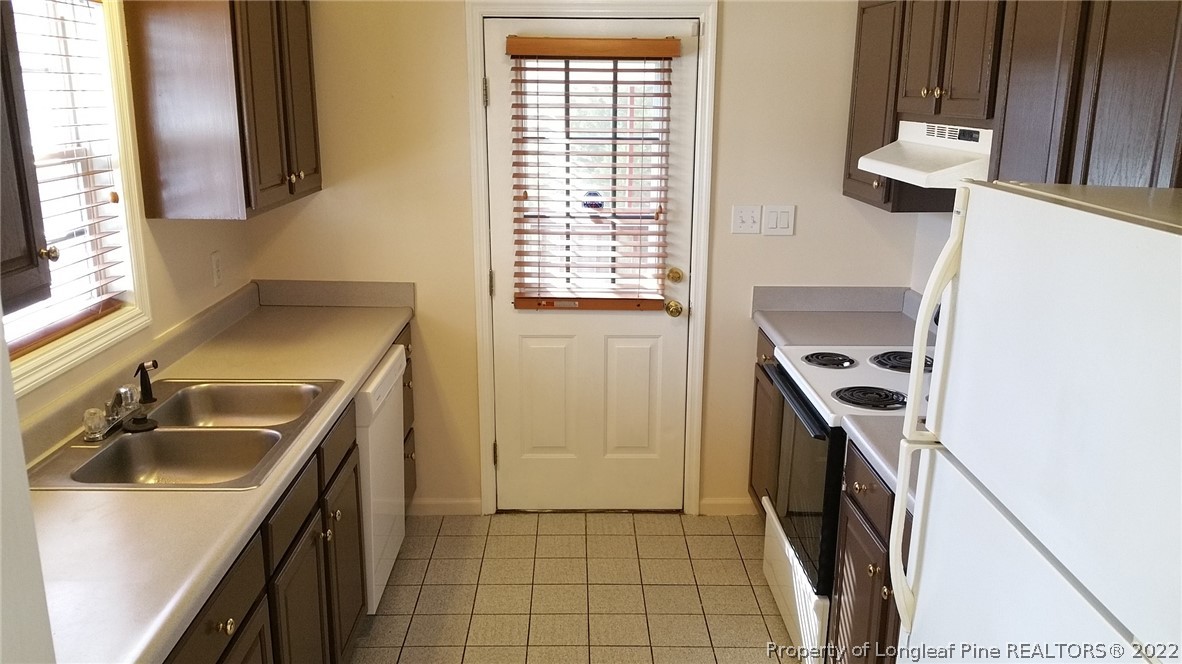 232 Rye Lane Raeford, NC 28376 - Photo 5 of 20 a kitchen with a sink and a stove top oven