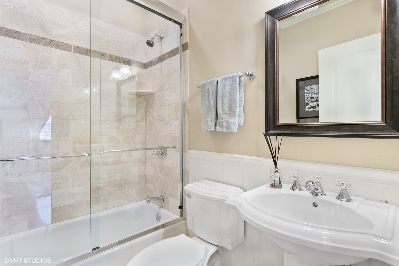 1215 West School Street, Unit 2E Chicago, IL 60657 - Photo 12 of 16 a bathroom with a bathtub shower sink vanity and toilet