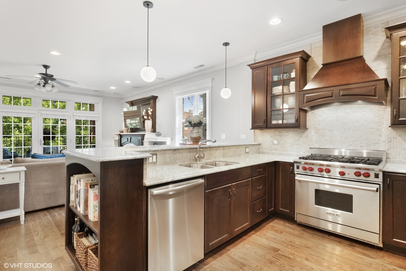 1215 West School Street, Unit 2E Chicago, IL 60657 - Photo 5 of 16 a kitchen with stainless steel appliances granite countertop a stove a sink and a wooden floors
