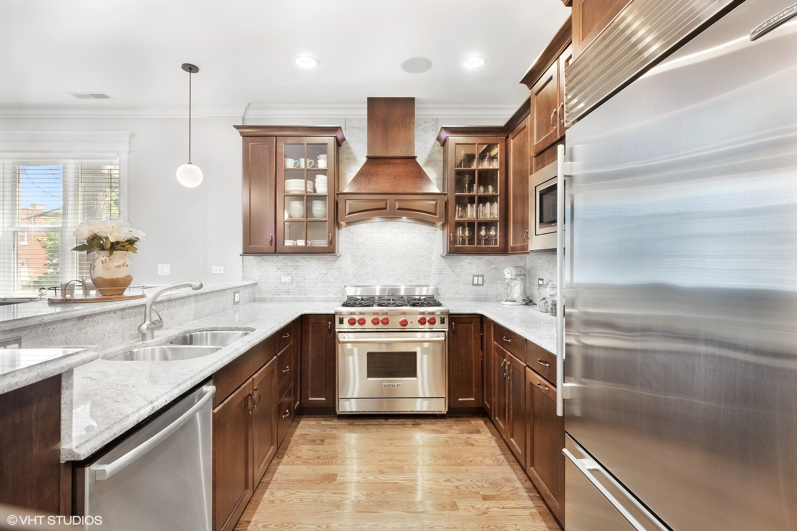 1215 West School Street, Unit 2E Chicago, IL 60657 - Photo 6 of 16 a kitchen with stainless steel appliances granite countertop a sink and a stove