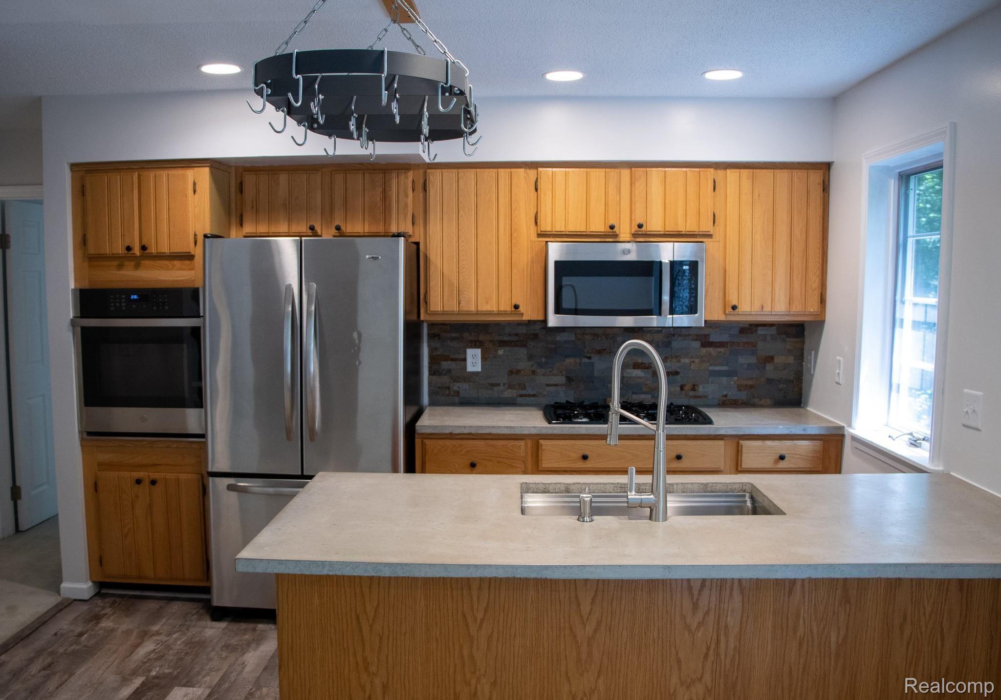 3536 East Allen Road Howell, MI 48855 - Photo 4 of 25 Newly updated kitchen with custom concrete counter tops!