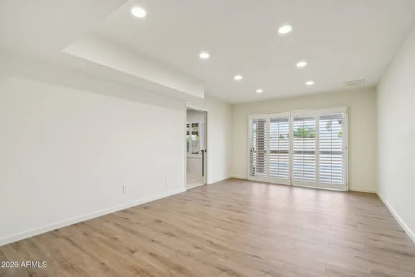 a view of a kitchen with furniture and wooden floor
