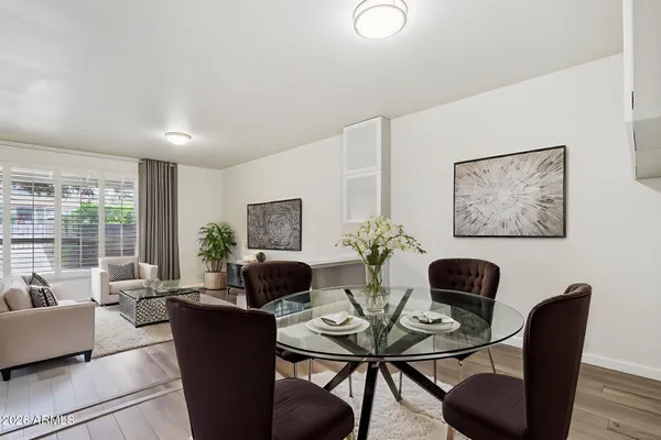 a kitchen with stainless steel appliances a sink a stove a refrigerator cabinets and living room view