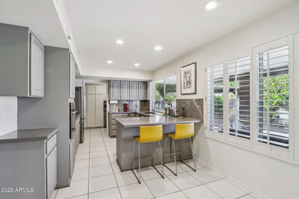 a kitchen with white cabinets and white appliances