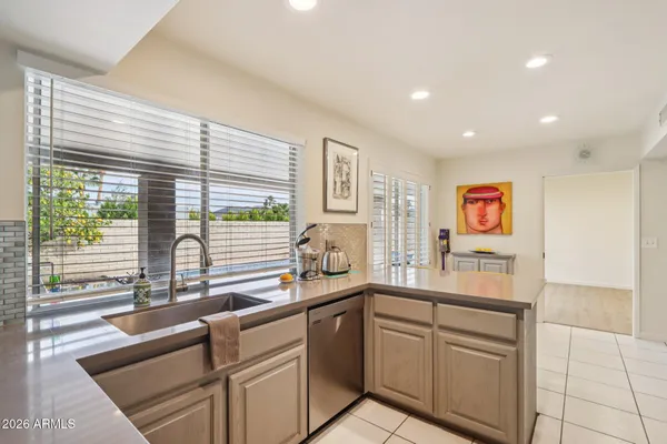 a bathroom with a granite countertop toilet sink and mirror