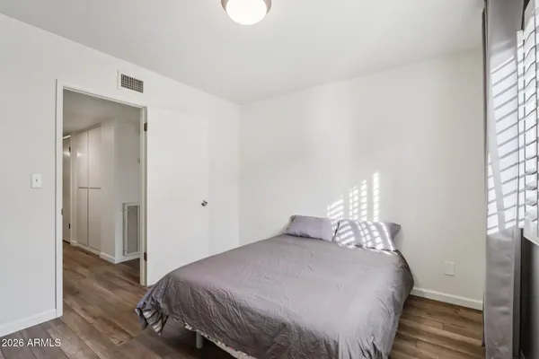 a bedroom with a bed and a table