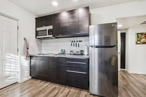 a view of a house with swimming pool and sitting area