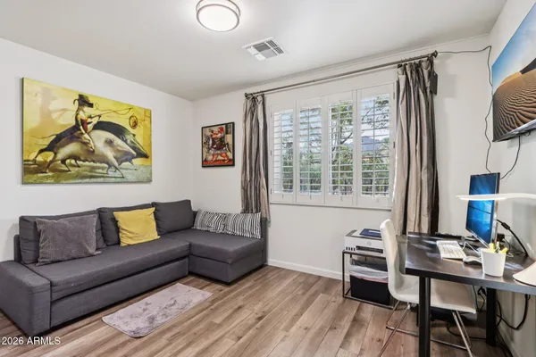 an aerial view of residential houses with outdoor space and trees