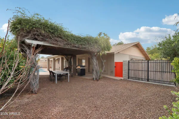 a view of a house with swimming pool in front of it