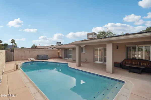a view of a house with backyard and sitting area