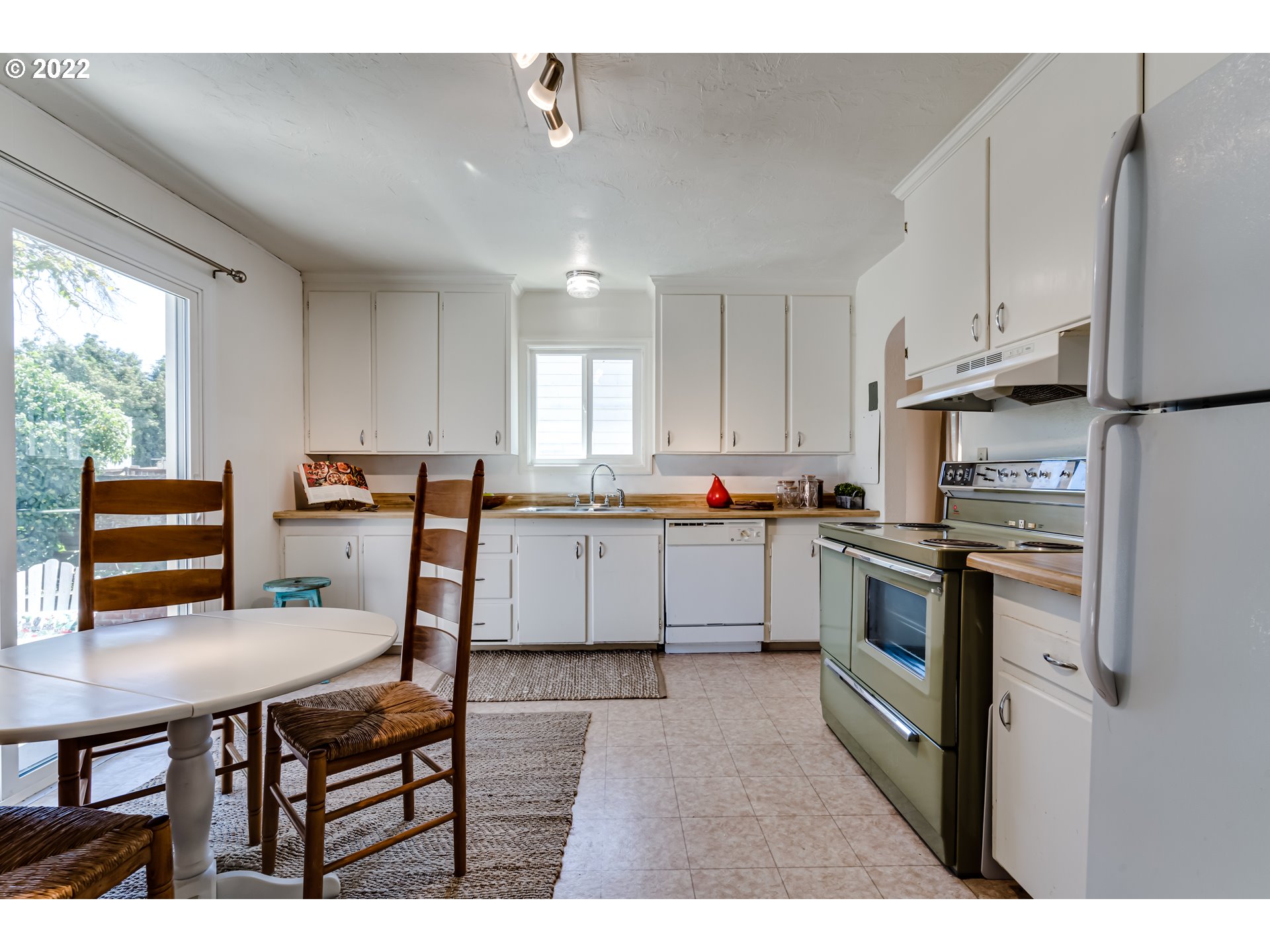 2691 Game Farm Road Springfield, OR 97477 - Photo 11 of 23 a kitchen with cabinets stainless steel appliances and a window