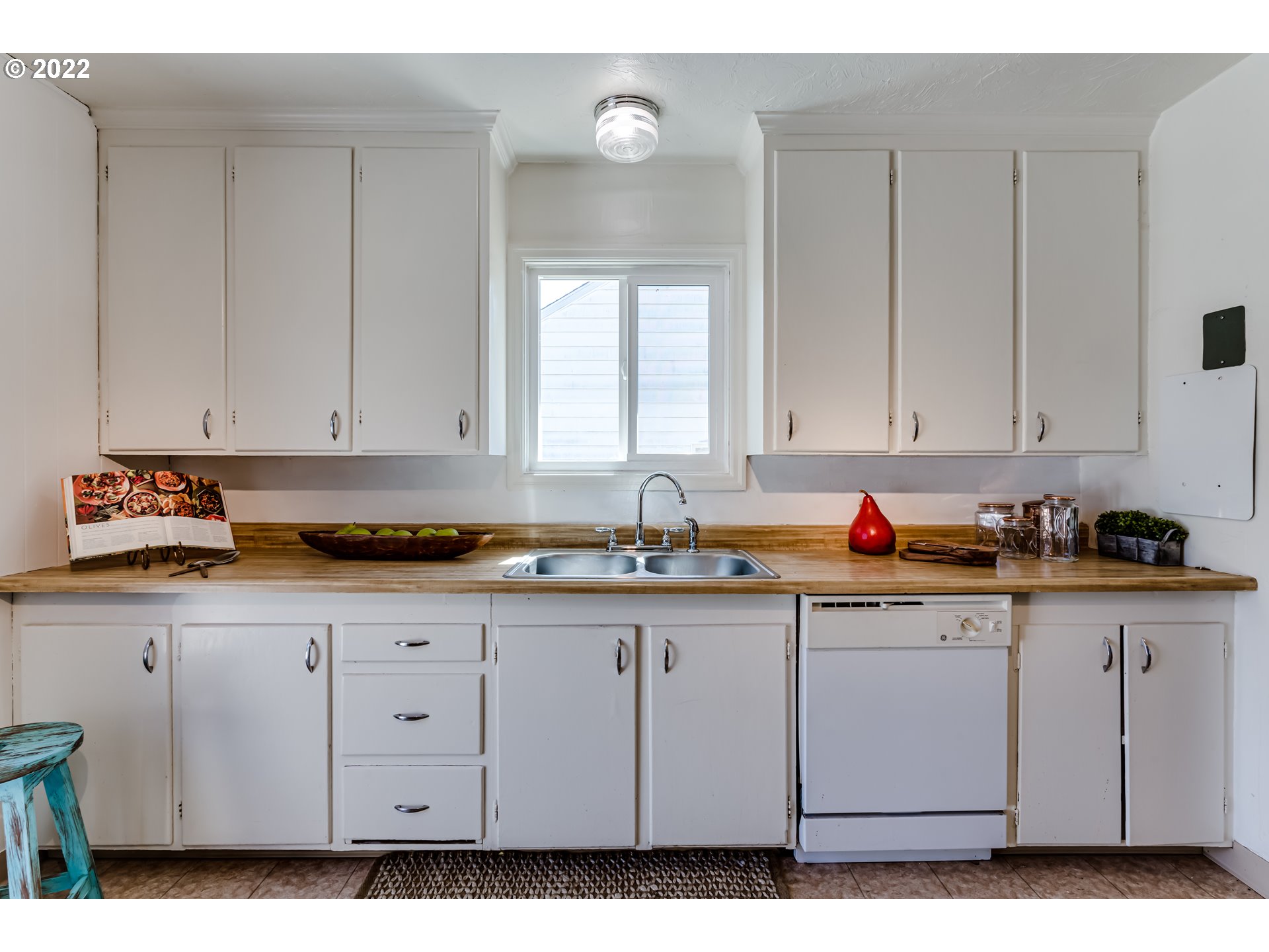 2691 Game Farm Road Springfield, OR 97477 - Photo 12 of 23 a kitchen with granite countertop white cabinets and sink