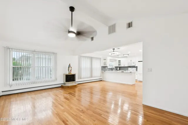 a view of a kitchen with granite countertop a stove and a floor to ceiling window