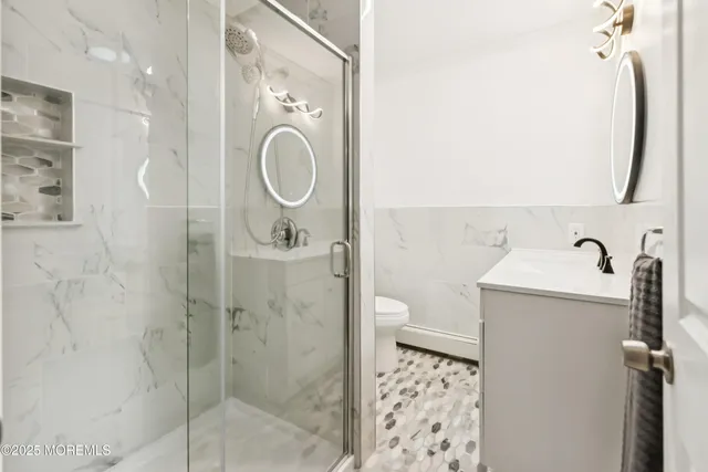 a bathroom with a shower and mirror