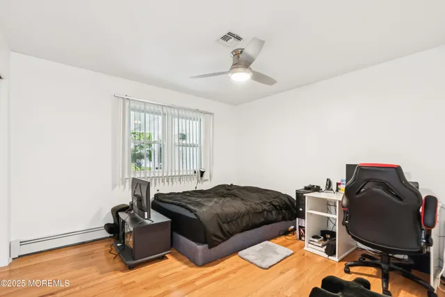 a bedroom with a bed dresser and a window