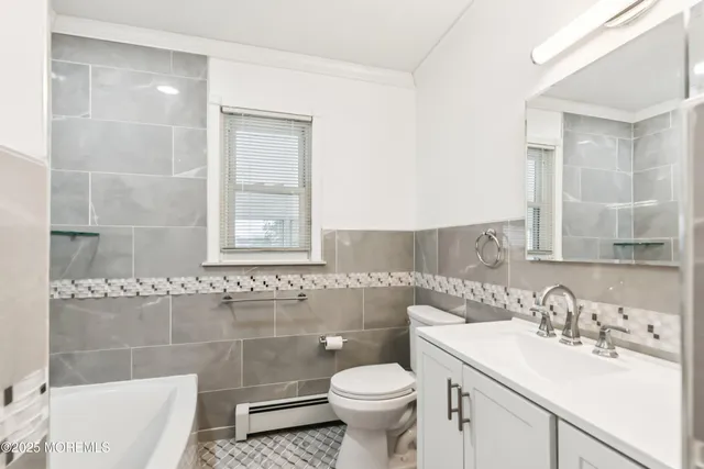 a bathroom with a sink toilet and vanity