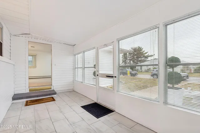 a hallway with white walls and windows