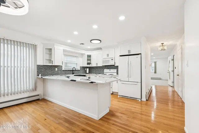 a kitchen with stainless steel appliances a sink stove and refrigerator