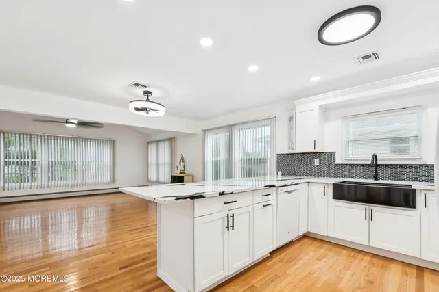 a kitchen with stainless steel appliances granite countertop a sink and cabinets