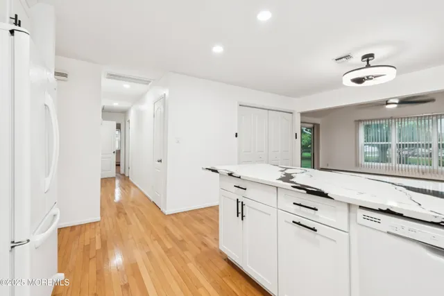 a kitchen with granite countertop a sink and a stove top oven