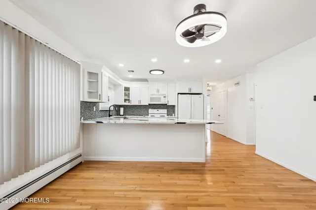 a view of kitchen and kitchen with wooden floor