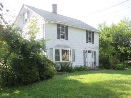 a house that has a tree in front of it