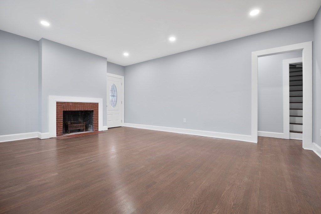 274 Archer Street Fall River, MA 02720 - Photo 12 of 29 a view of an empty room with wooden floor and a fireplace