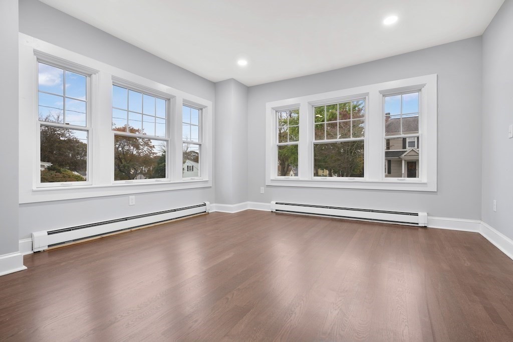 274 Archer Street Fall River, MA 02720 - Photo 15 of 29 a view of an empty room with wooden floor and windows