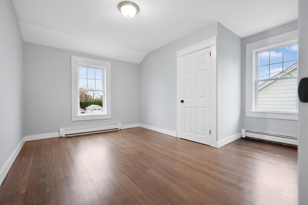 274 Archer Street Fall River, MA 02720 - Photo 19 of 29 an empty room with wooden floor and windows