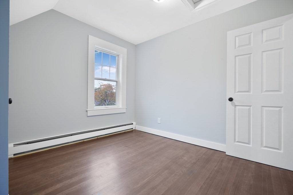 274 Archer Street Fall River, MA 02720 - Photo 22 of 29 an empty room with wooden floor and windows