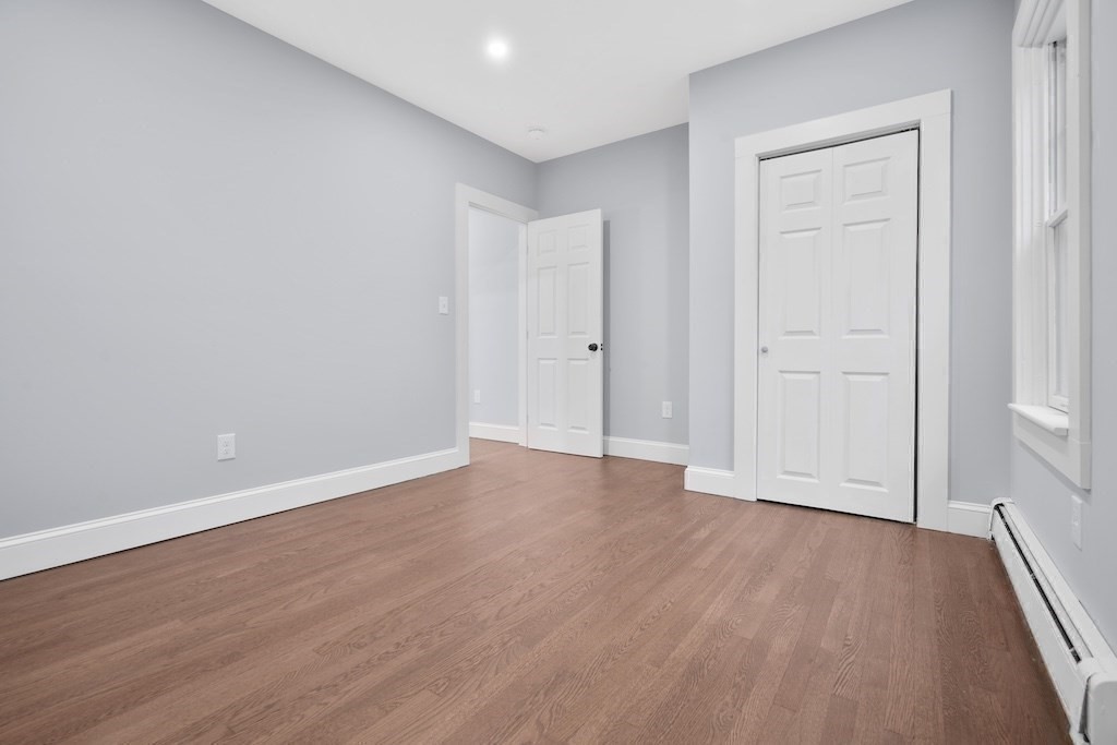 274 Archer Street Fall River, MA 02720 - Photo 24 of 29 a view of an empty room with wooden floor and a window