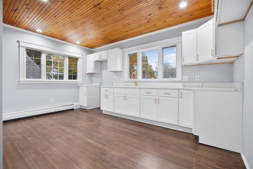 274 Archer Street Fall River, MA 02720 - Photo 6 of 29 a view of a kitchen with wooden floor and electronic appliances