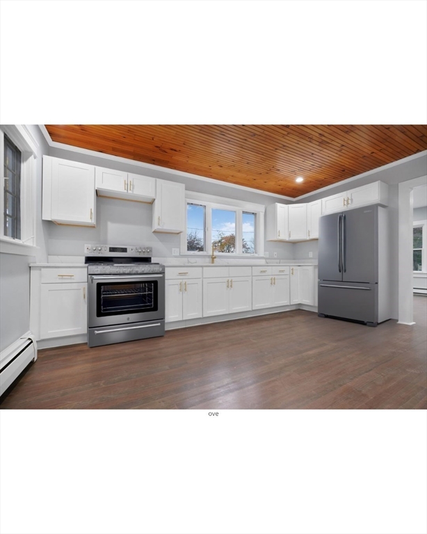 274 Archer Street Fall River, MA 02720 - Photo 7 of 29 a kitchen with a stove top oven and cabinets