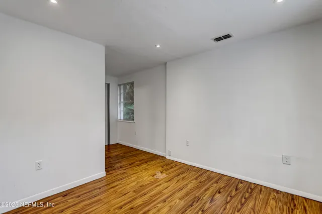 a view of a room with wooden floor and closet