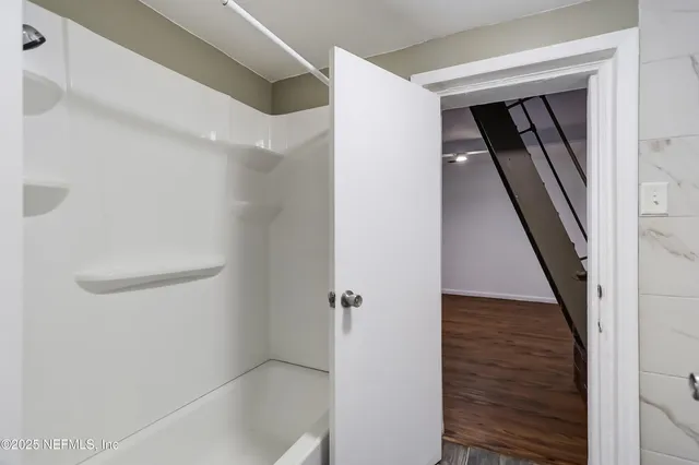 a bathroom with a sink toilet and shower
