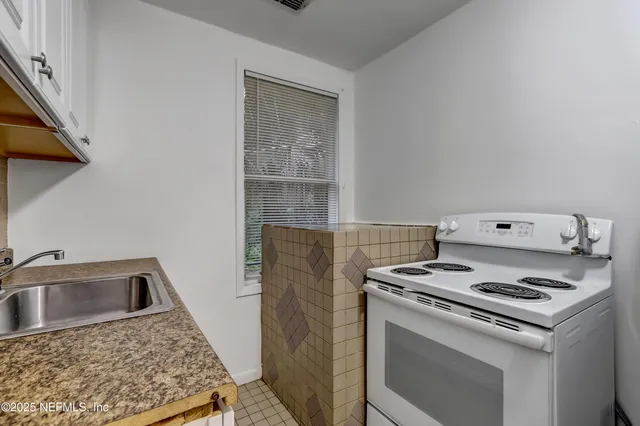 a kitchen that has a stove and a sink