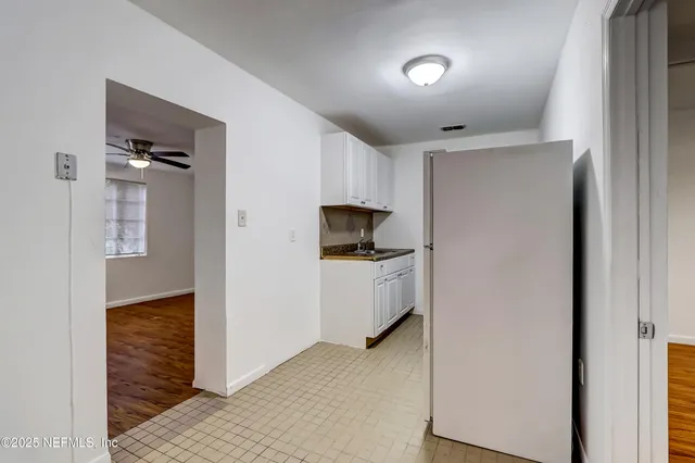 a view of a room with wooden floor and a window