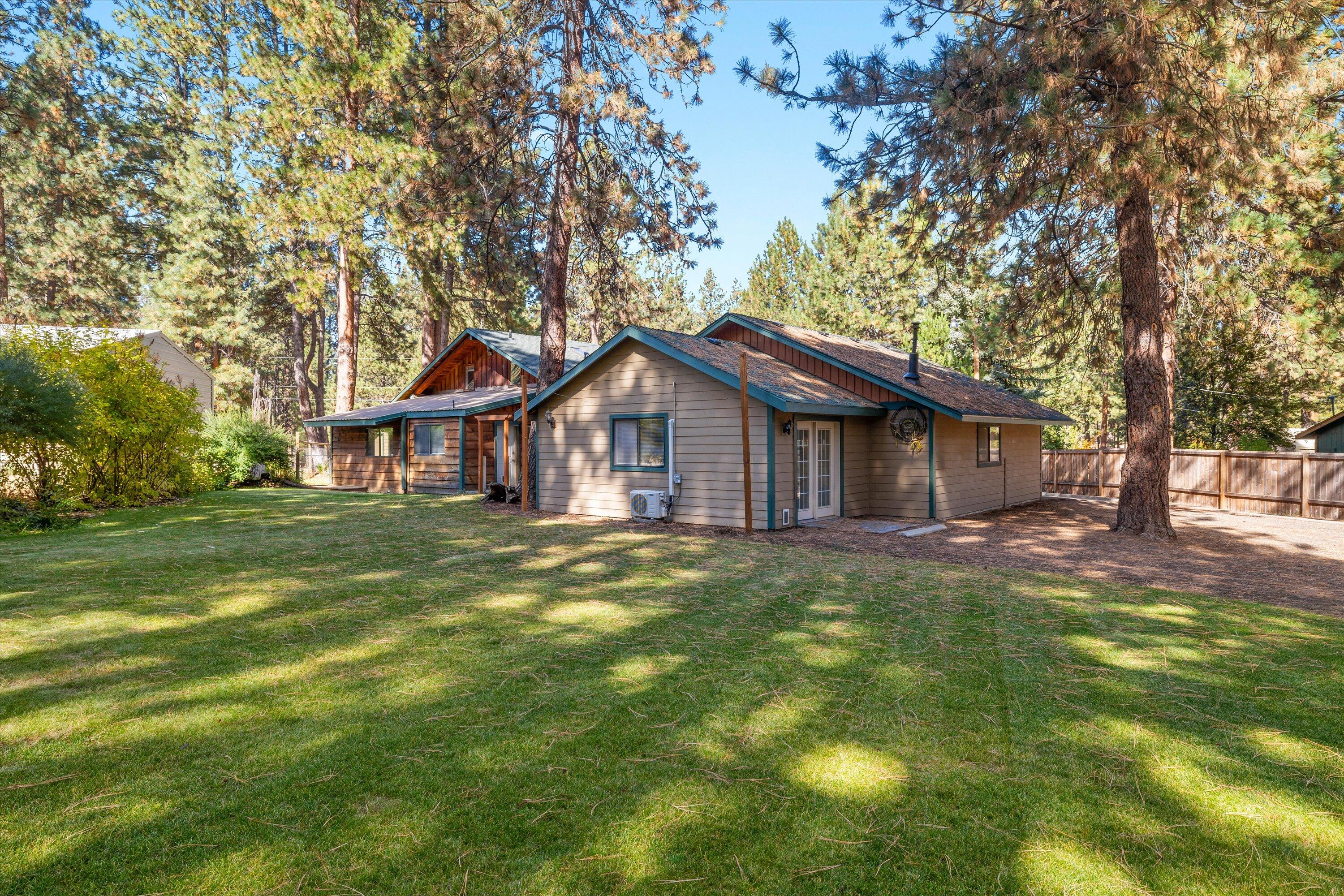 19245 Indian Summer Road Bend, OR 97702 - Photo 4 of 22 Beautiful back yard fenced and backs to canal. Separate entrance to attached studio in SHOP