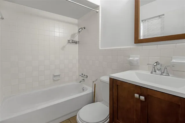 a bathroom with a sink toilet vanity and shower