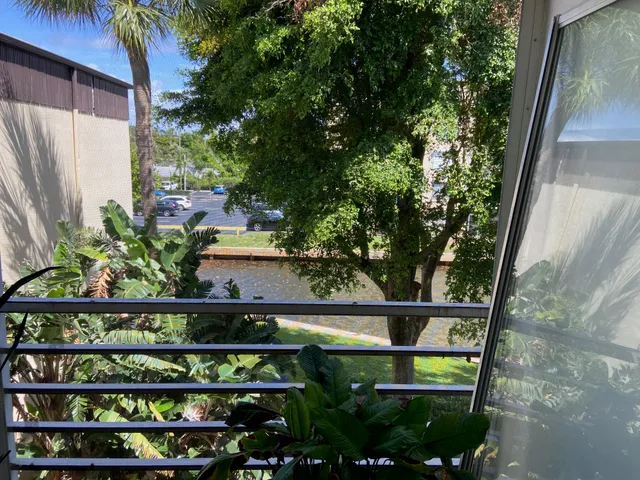 a bathroom with a sink a toilet a rug and a shower