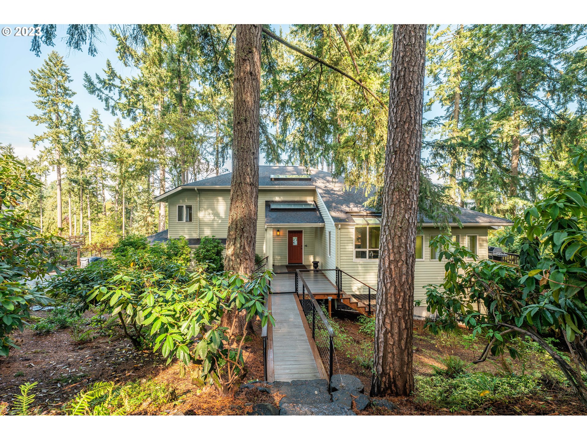 a view of a house with a tree in the background