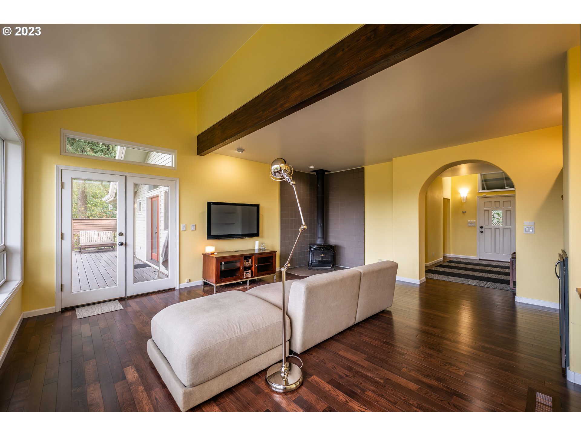 3955 Spring Boulevard Eugene, OR 97405 - Photo 13 of 48 a living room with couches and a flat screen tv with kitchen view