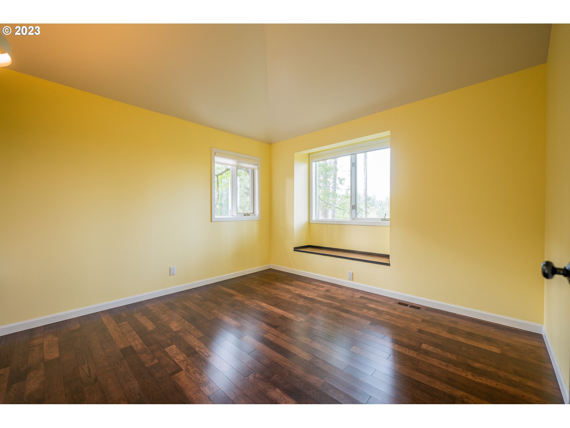 3955 Spring Boulevard Eugene, OR 97405 - Photo 27 of 48 a view of an empty room with wooden floor and a window