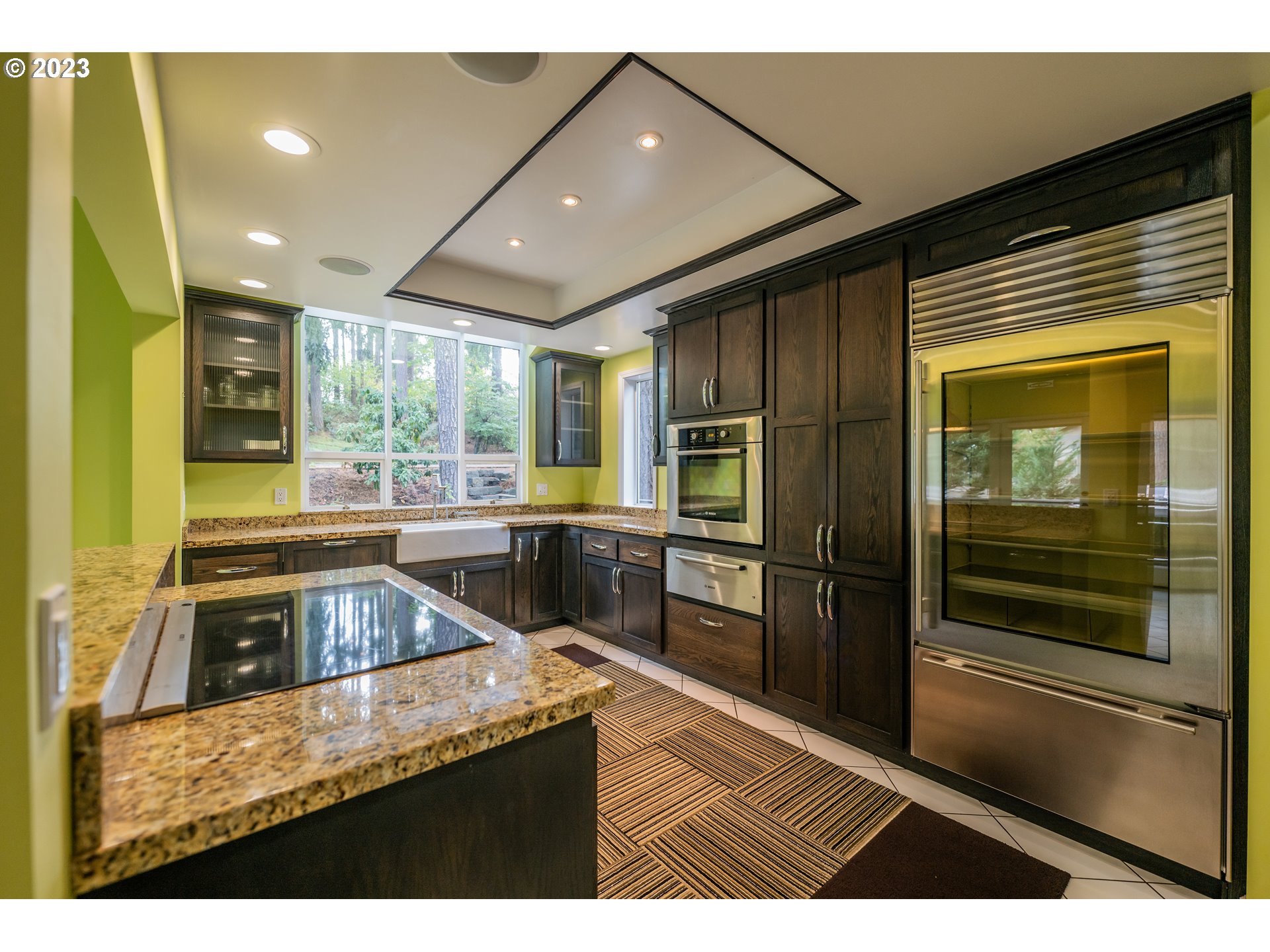 3955 Spring Boulevard Eugene, OR 97405 - Photo 9 of 48 a kitchen with stainless steel appliances granite countertop a refrigerator a stove and a sink with wooden cabinets