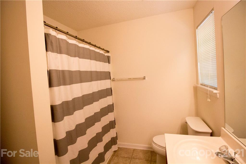 8360 Rudolph Road Charlotte, NC 28216 - Photo 14 of 20 a bathroom with a bathtub and a shower