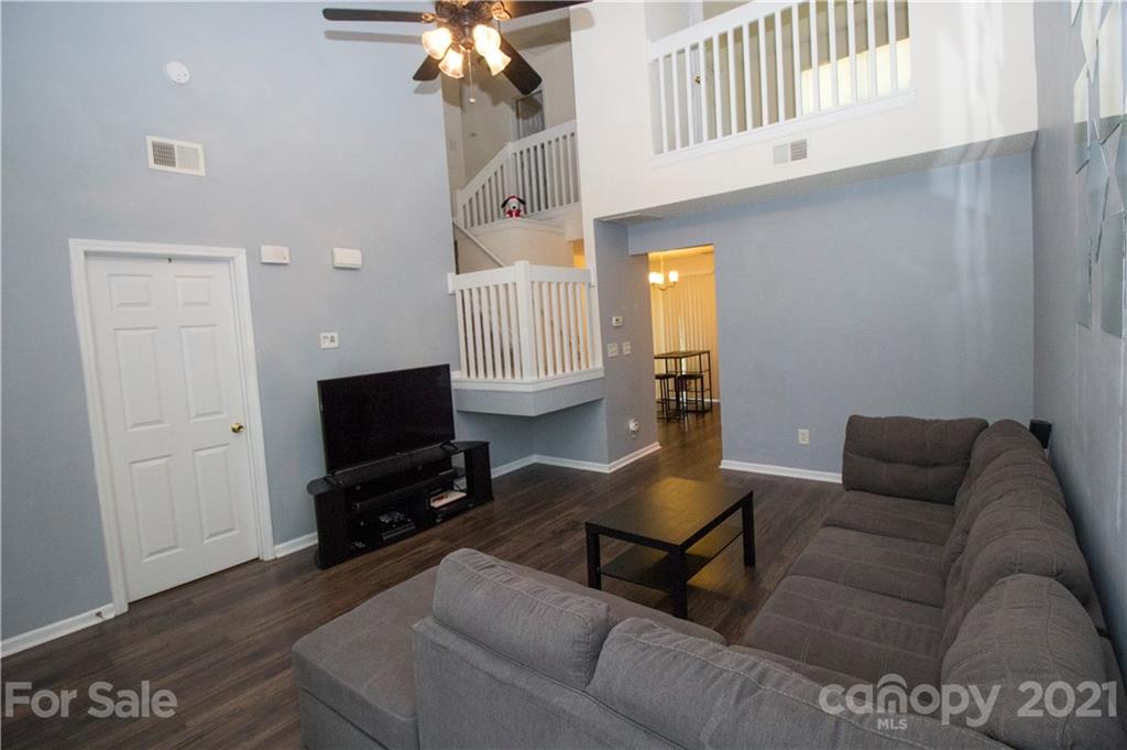 8360 Rudolph Road Charlotte, NC 28216 - Photo 3 of 20 a living room with furniture and a flat screen tv